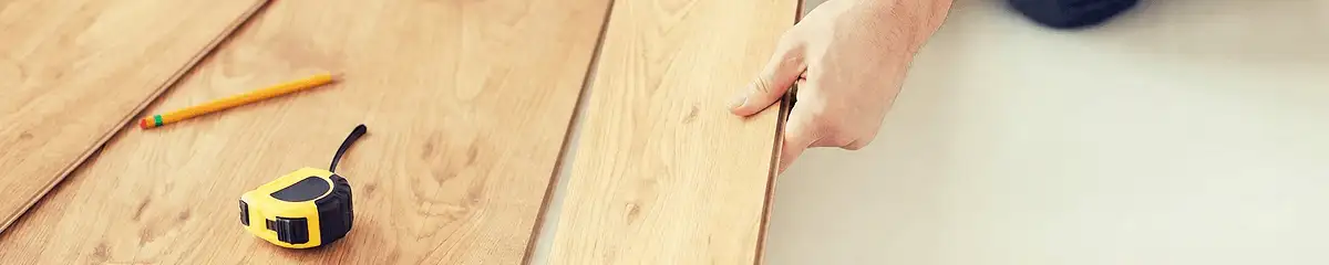 A professional installing wood flooring in Oakland, CA