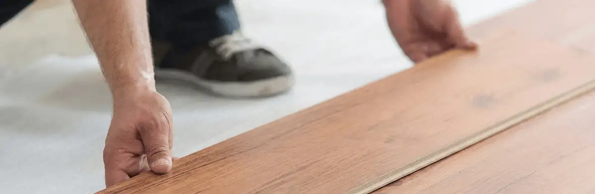 A professional installing laminate flooring in Oakland, CA